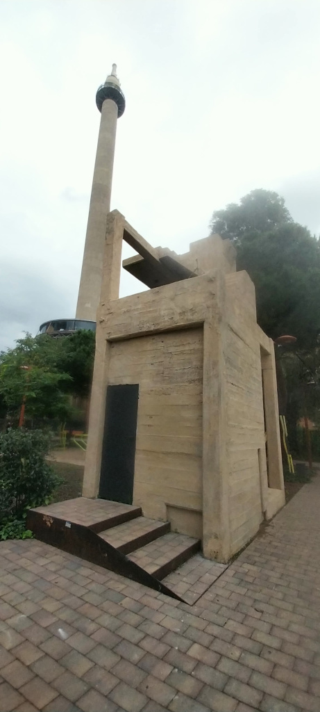 Vista de la caixa d'escala amb la xemeneia de la fàbrica Sanson al fons.