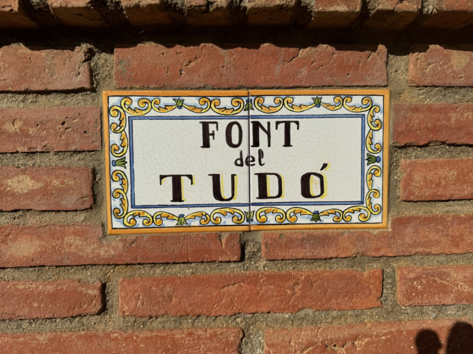  Font del Tudó. Plafó ceràmic amb el nom de la font. 